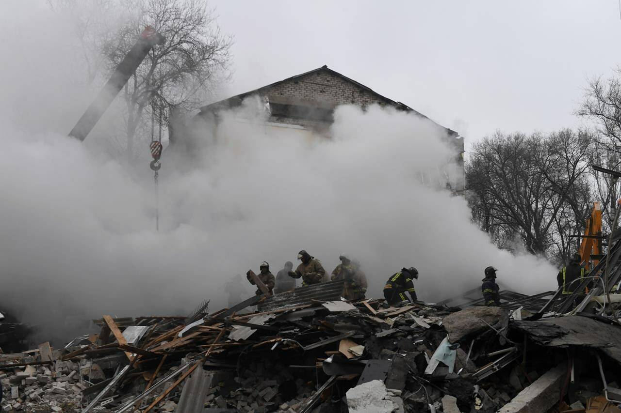 Donetsk’s emergency employees work at a site of a shopping center destroyed after what Russian officials in Donetsk said was a shelling by Ukrainian forces, in Donetsk, in Russian-controlled Donetsk region, eastern Ukraine, Monday, Jan. 16, 2023. (AP Photo)