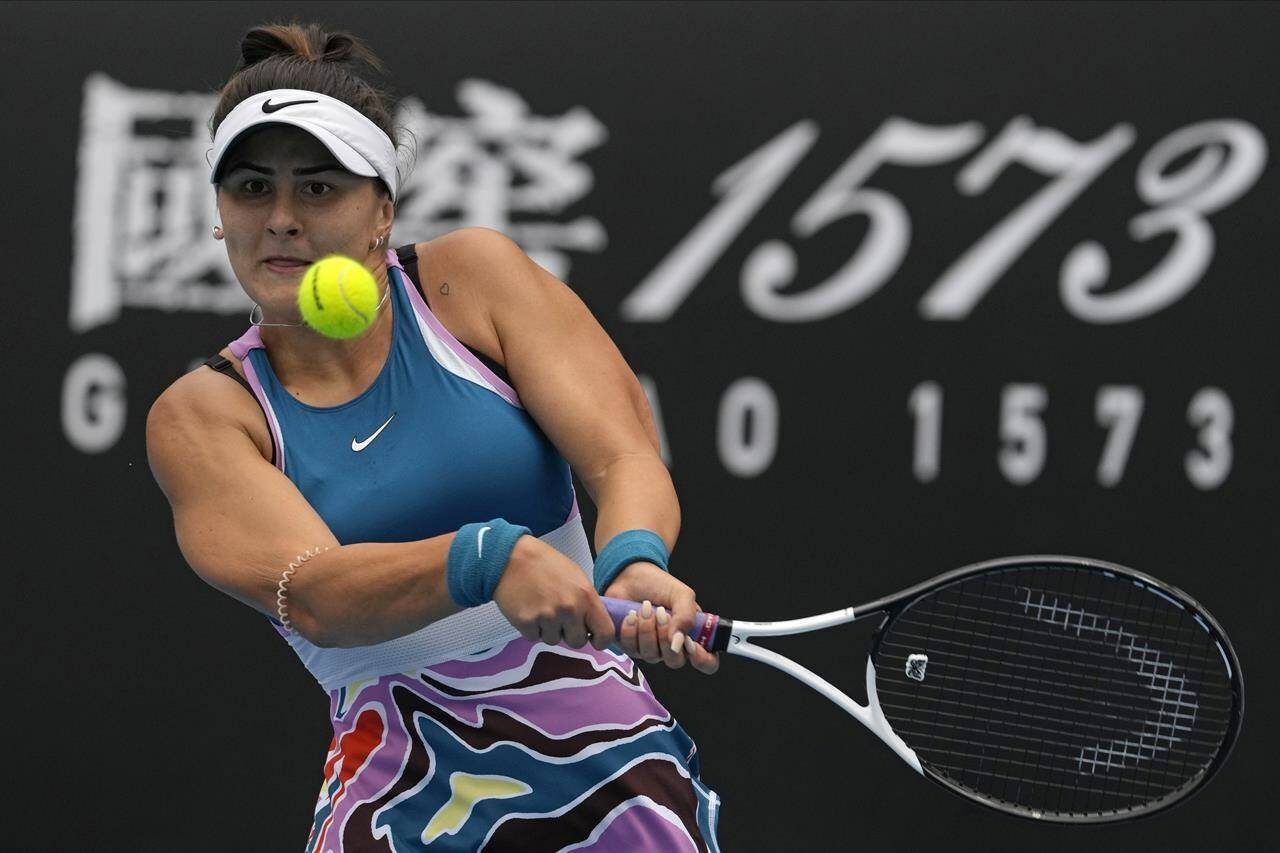 Bianca Andreescu of Canada plays a backhand return to Marie Bouzkova of the Czech Republic during their first round match at the Australian Open tennis championship in Melbourne, Australia, Monday, Jan. 16, 2023. (AP Photo/Ng Han Guan)