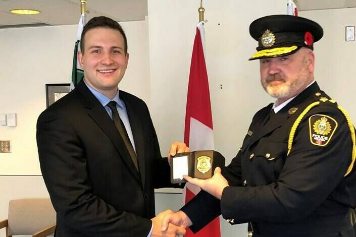 Constable Mathieu Nolet, left, poses with Chief Donovan Fisher during a swearing-in ceremony in Nelson, B.C., in this undated handout photo. The City of Nelson in B.C. says Nolet, who suffered critical injuries in an avalanche that killed a colleague last week is making “incremental progress” but faces a long road to recovery. THE CANADIAN PRESS/HO - City of Nelson