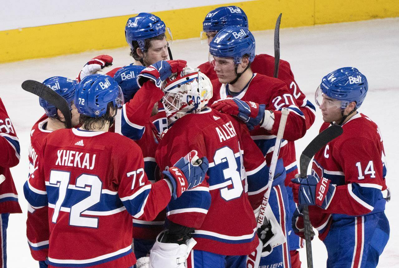 Montreal Canadiens goaltender Jake Allen is congratulated by teammates after stopping the Calgary Flames in the shootout to win 2-1 in NHL hockey action in Montreal, Monday, Dec. 12, 2022. When did the Canadiens last win the Stanley Cup? (THE CANADIAN PRESS/Paul Chiasson)