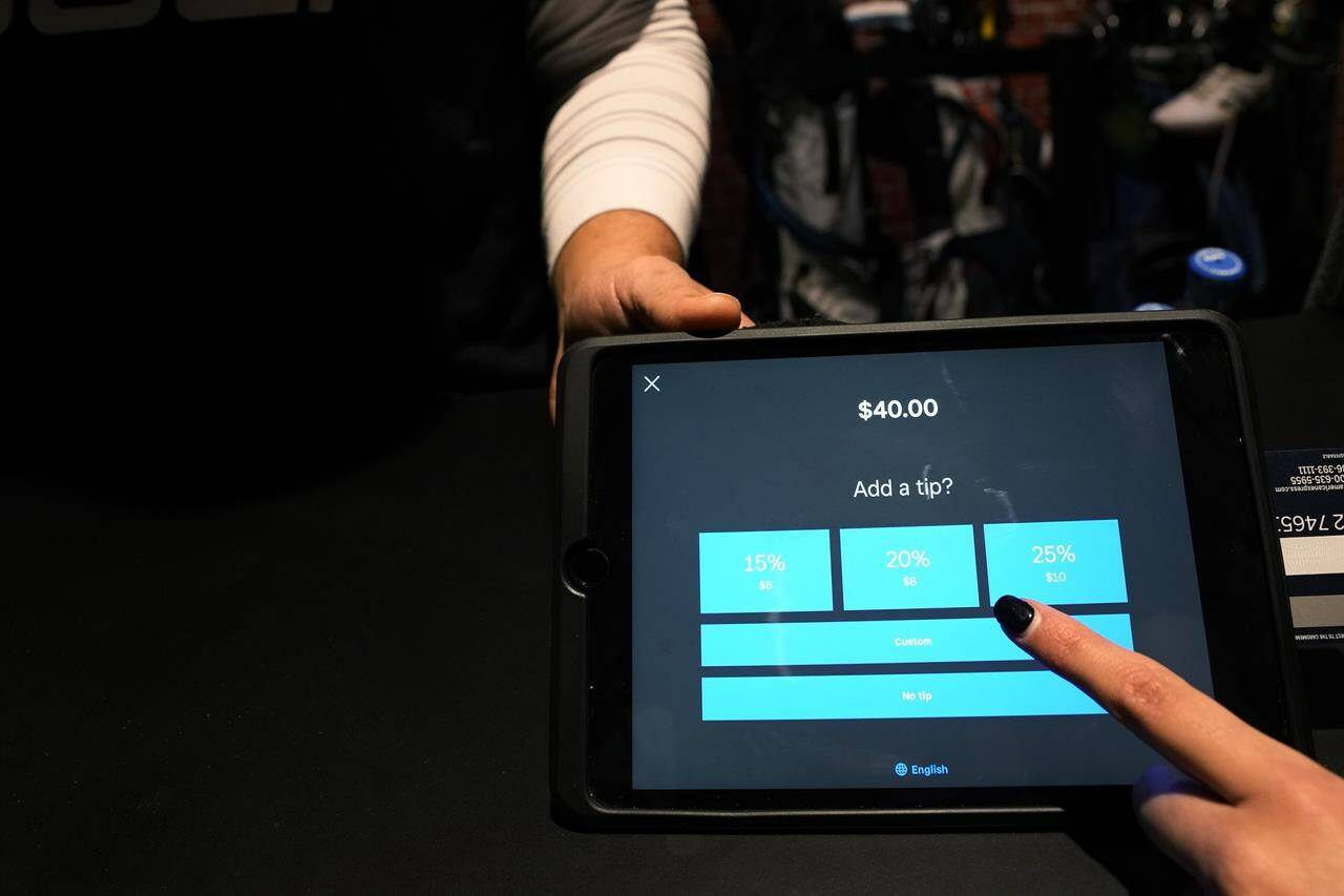 A tipping option is displayed on a card reader tablet at X-Golf indoor golf in Glenview, Ill., Friday, Jan. 20, 2023. Tipping fatigue, it seems, is swarming America as more businesses adopt digital payment methods that automatically prompts customers to leave a gratuity. (AP Photo/Nam Y. Huh)