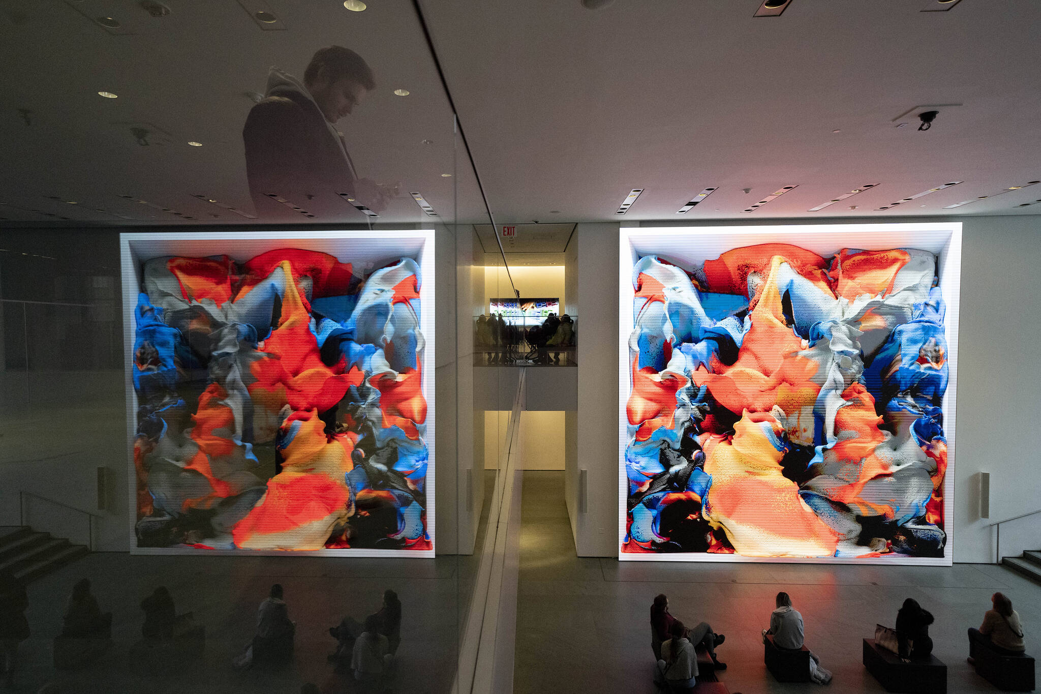Visitors view artist Refik Anadol’s “Unsupervised” exhibit at the Museum of Modern Art, Wednesday, Jan. 11, 2023, in New York. The new AI-generated installation is meant to be a thought-provoking interpretation of the New York City museum’s prestigious collection. (AP Photo/John Minchillo)