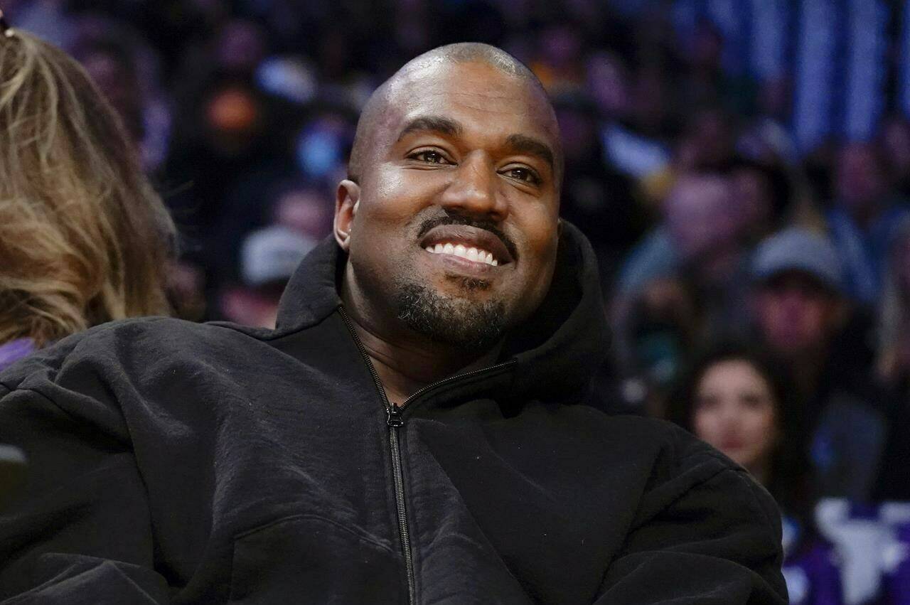 FILE - Kanye West, known as Ye, watches the first half of an NBA basketball game between the Washington Wizards and the Los Angeles Lakers in Los Angeles, on March 11, 2022. A senior Australian government minister said Wednesday, Jan. 25, 2023, that Ye, could be refused a visa due to antisemitic comments if he attempts to visit Australia. (AP Photo/Ashley Landis, File)