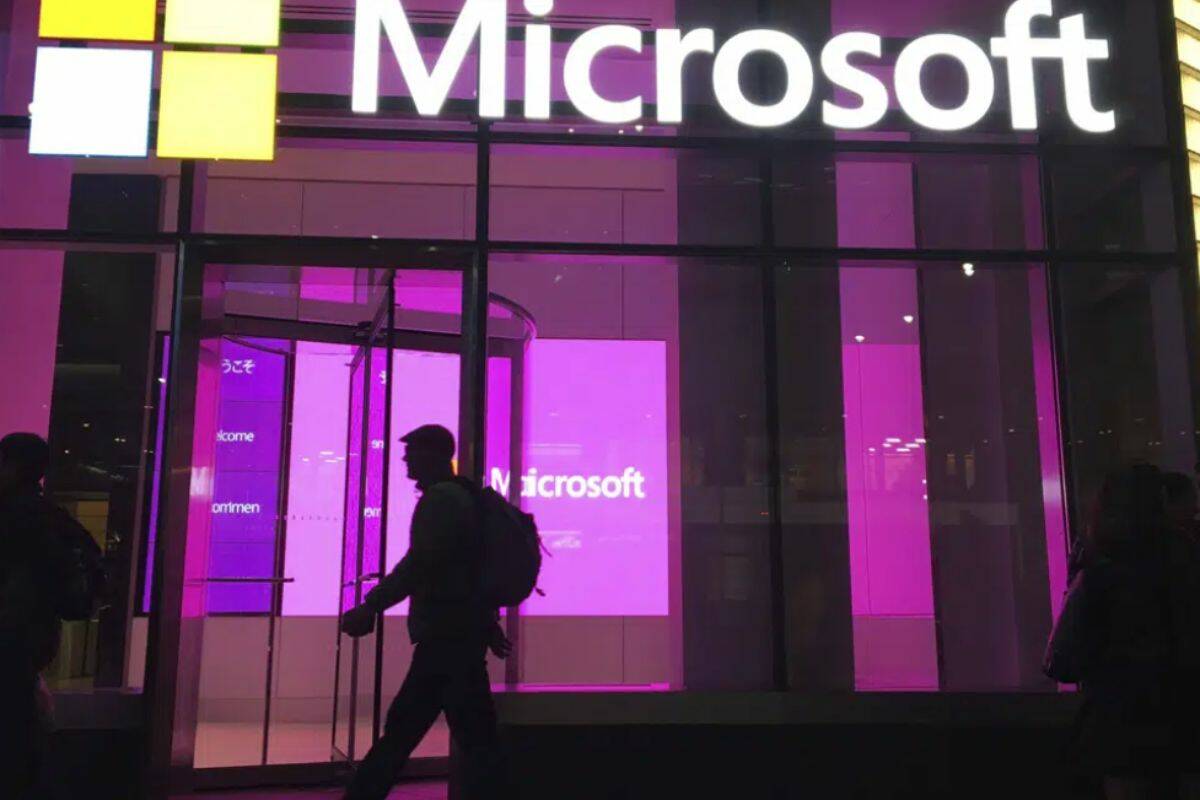 FILE - People walk past a Microsoft office in New York, Nov. 10, 2016. On Tuesday, Jan. 24, 2023, Microsoft reported a 12% drop in profit for the October-December 2022 quarter, reflecting the economic uncertainty it said led to its decision to cut 10,000 workers. (AP Photo/Swayne B. Hall, File)