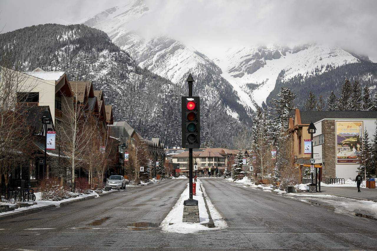 The empty streets of Banff are seen as Parks Canada is restricting vehicles in the national parks and national historic sites in Banff, Alta., on March 24, 2020. Banff tourism officials are joining the call for better management of visitor traffic in the most heavily visited parts of the national park. In a document outlining its development plans for the next decade, Banff and Lake Louise Tourism says it wants to reduce damaging traffic bottlenecks through improved public transit and fewer private vehicles. THE CANADIAN PRESS/Jeff McIntosh