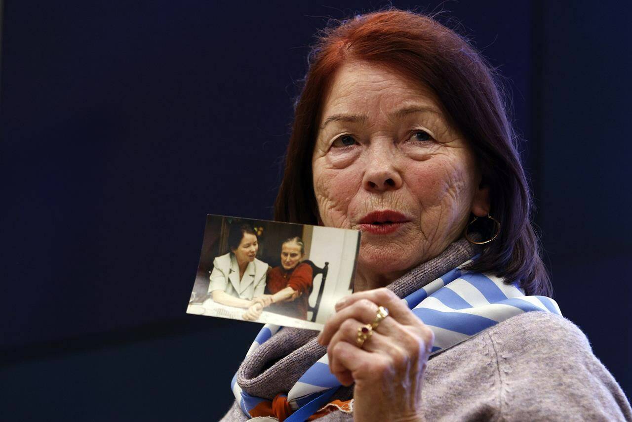 Holocaust survivor Stefania Wernik shows her family picture as she attends a meeting of survivors with media in Oswiecim, Poland, Thursday, Jan. 26, 2023. Survivors of Auschwitz-Birkenau are gathering to commemorate the 78th anniversary of the liberation of the Nazi German death camp in the final months of World War II, amid horror that yet another war has shattered the peace in Europe. The camp was liberated by Soviet troops on Jan. 27, 1945. (AP Photo/Michal Dyjuk)