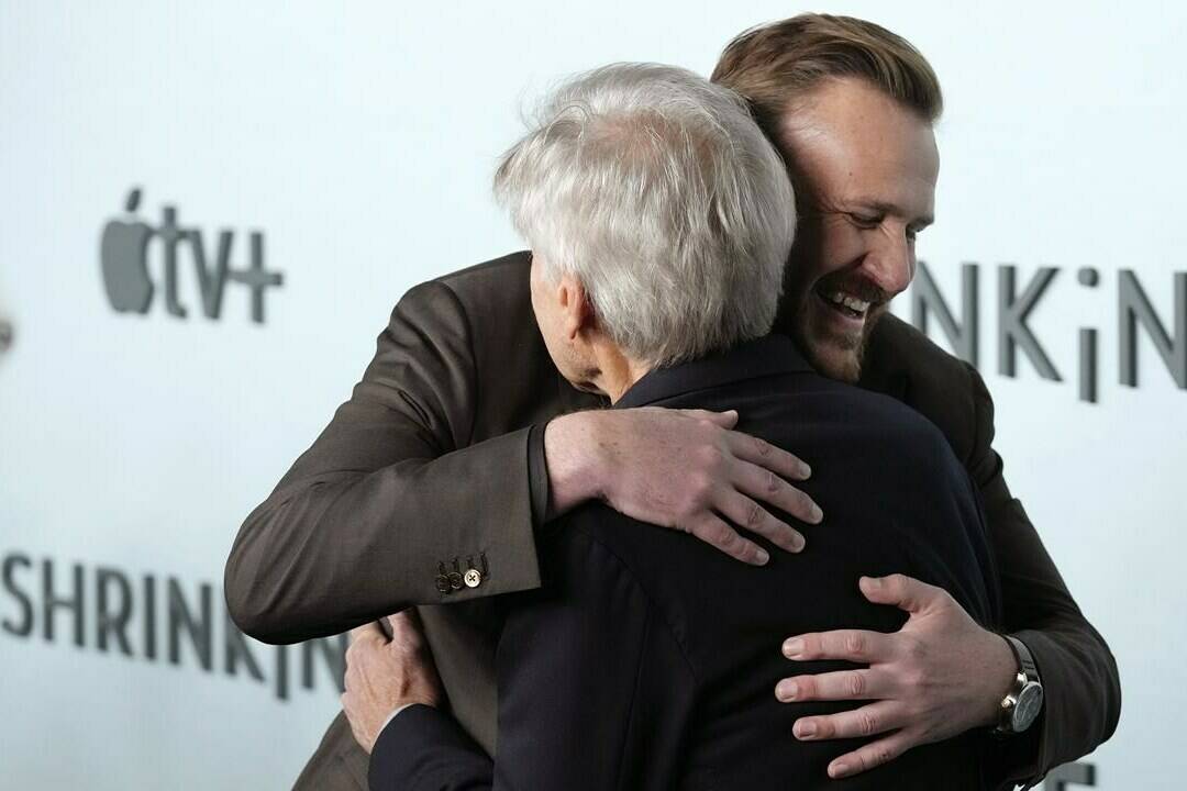 Jason Segel, rear, co-creator/co-writer/executive producer/cast member in “Shrinking,” embraces cast member Harrison Ford at the premiere of the Apple TV+ series, Thursday, Jan. 26, 2023, at the Directors Guild of America in Los Angeles. (AP Photo/Chris Pizzello)
