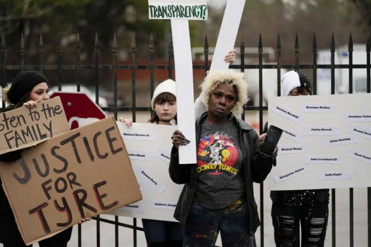 A group of demonstrators protest outside a police precinct in response to the death of Tyre Nichols, who died after being beaten by Memphis police officers, in Memphis, Tenn., Sunday, Jan. 29, 2023. (AP Photo/Gerald Herbert)