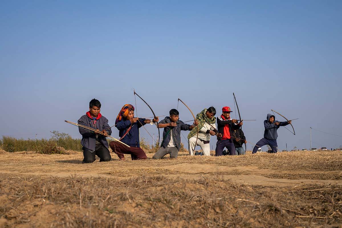 A group of local men practice archery on a ridge overlooking the Laitlum Canyon about 20km (12 miles) from Shillong, India, Sunday, Jan. 22, 2023. In villages scattered across the northeastern Indian state of Meghalaya an ancient tradition of archery still continues and regular competitions are held between different localities. (AP Photo/Ashwini Bhatia)