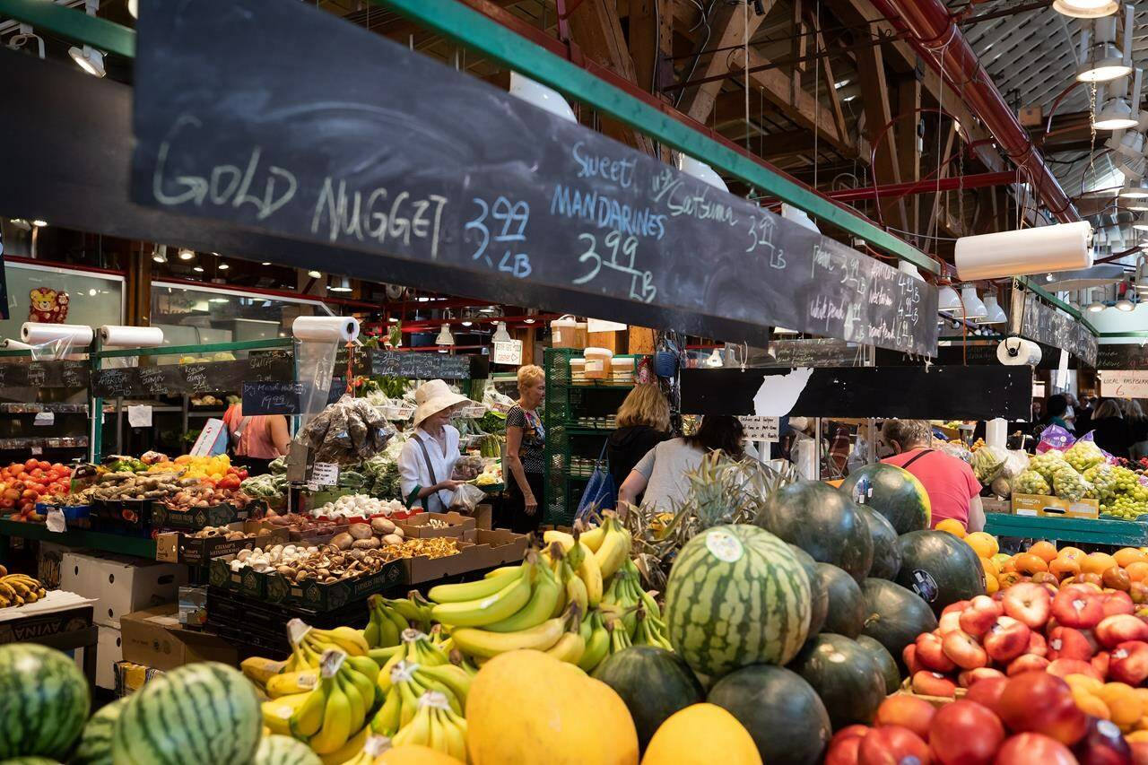 People shop for produce at the Granville Island Market in Vancouver, on Wednesday, July 20, 2022. Canada’s inflation rate was up 8.1 per cent in June compared with a year ago, its largest yearly change since January 1983. Statistics Canada will release its November reading of gross domestic product this morning.THE CANADIAN PRESS/Darryl Dyck