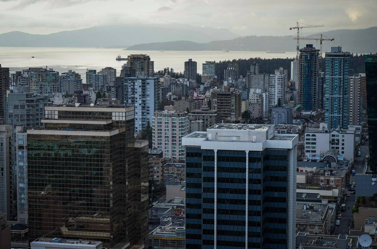 Home sales in Greater Vancouver are predicted to stay in line with last year’s slower pace, while prices will inch up slightly. Office towers, condos and apartment buildings are seen in downtown and the West End of Vancouver, on Thursday, Jan. 19, 2023. THE CANADIAN PRESS/Darryl Dyck