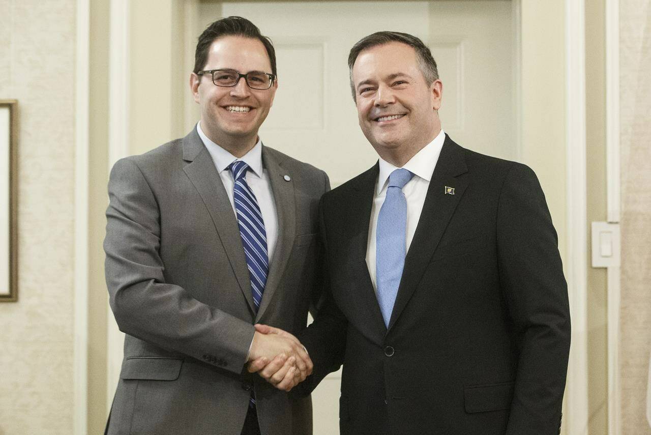Former Alberta premier Jason Kenney shakes hands with Demetrios Nicolaides, Minister of Advanced Education, in Edmonton on Tuesday April 30, 2019. The Alberta government says changes are coming to further protect free speech on campuses as a former professor speaking out on so-called “woke” policies prepares for a showdown with the University of Lethbridge.THE CANADIAN PRESS/Jason Franson