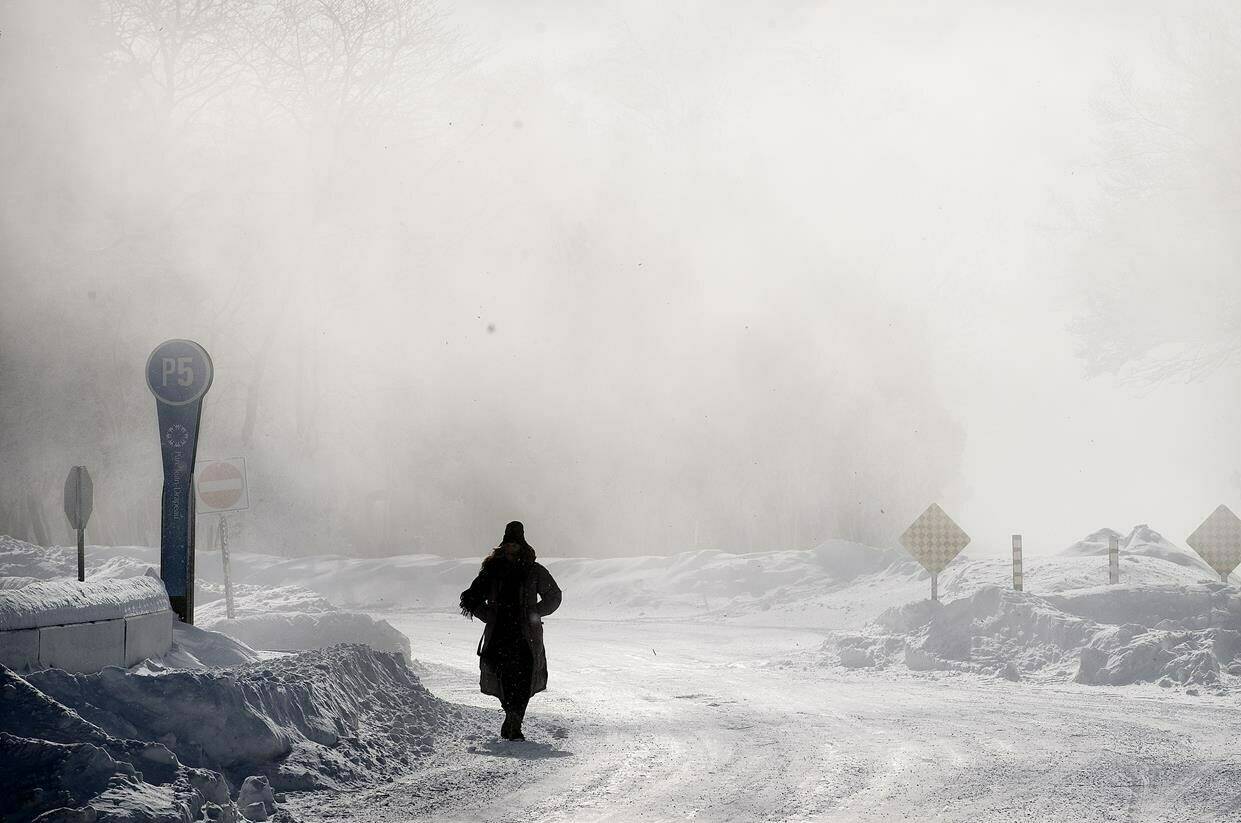 A person walks through a park during frigid temperatures in Montreal, Saturday, February 4, 2023. Environment Canada has issued extreme cold weather alerts impacting six provinces — from Ontario to Newfoundland and Labrador, and communities in Nunavut and the Northwest Territories. THE CANADIAN PRESS/Graham Hughes
