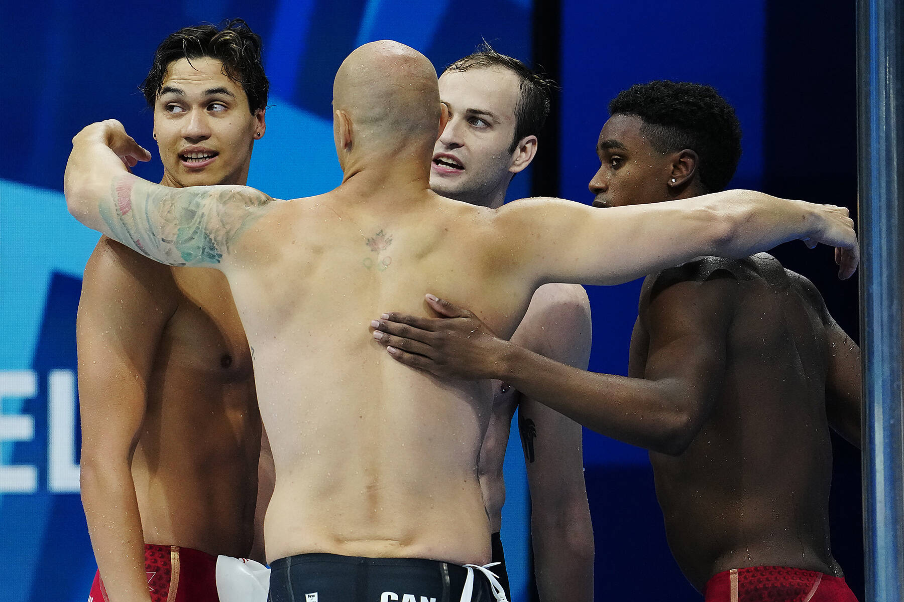 Canada’s Markus Thormeyer (left) huddles with Brent Hayden, Yuri Kisil and Joshua Liendo following a fourth place finish in the men’s 4 x 100m freestyle relay during the Tokyo Olympics on Monday, July 26, 2021. (THE CANADIAN PRESS/Frank Gunn photo)