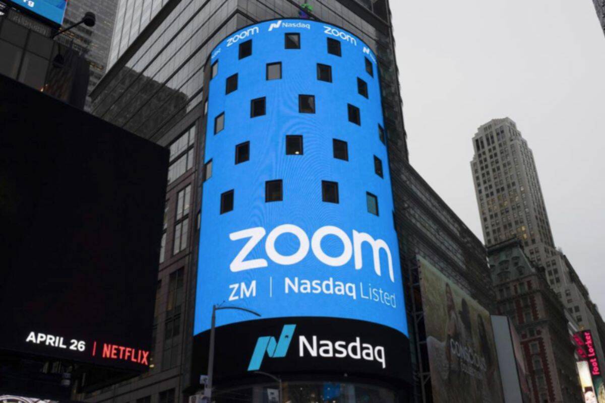 FILE - This April 18, 2019, file photo shows a sign for Zoom Video Communications ahead of the company's Nasdaq IPO in New York. The video-conferencing service is cutting about 1,300 jobs, or approximately 15% of its workforce. CEO Eric Yuan said in a blog post Tuesday, Feb. 7, 2023, that the company ramped up staffing during the COVID-19 pandemic, when businesses became increasingly reliant on its service as people worked from home. Yuan said Zoom grew three times in size within 24 months to manage demand. (AP Photo/Mark Lennihan, File)