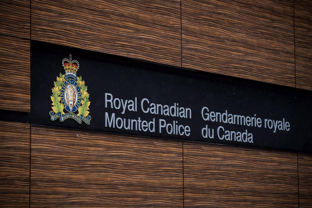 The RCMP logo is seen outside Royal Canadian Mounted Police “E” Division Headquarters, in Surrey, B.C., on Friday April 13, 2018. Two people have died in a house fire in North Vancouver. A statement from North Vancouver RCMP says the blaze engulfed the single family home at about 3 a.m. THE CANADIAN PRESS/Darryl Dyck