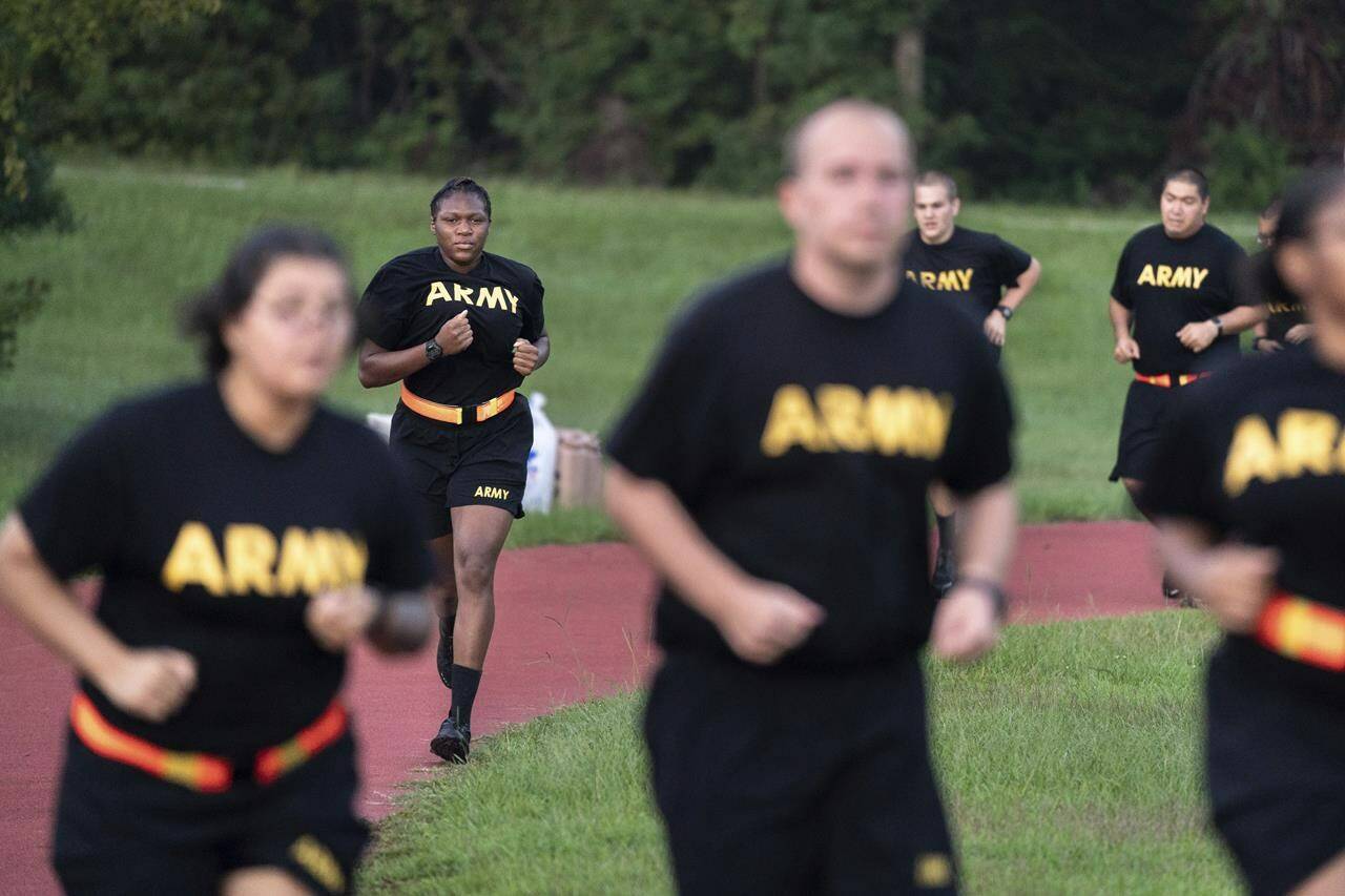 FILE - Students in the new Army prep course run around a track during physical training exercises at Fort Jackson in Columbia, S.C., Aug. 27, 2022. The new program prepares recruits for the demands of basic training. The Army is trying to recover from its worst recruiting year in decades, and officials say those recruiting woes are based on traditional hurdles. The Army is offering new programs, advertising and enticements to try to change those views and reverse the decline. (AP Photo/Sean Rayford, File)