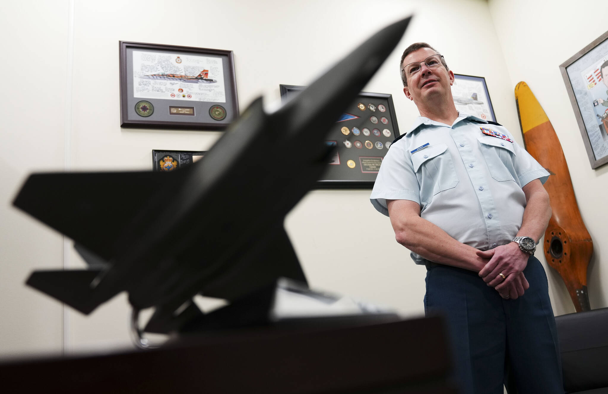 A model of a F-35 fighter jet sits on the desk of Lt.-Gen. Eric Kenny as he poses for a portrait at the National Defence Headquarters (Carling) in Ottawa on Thursday, Feb. 9, 2023. THE CANADIAN PRESS/Sean Kilpatrick