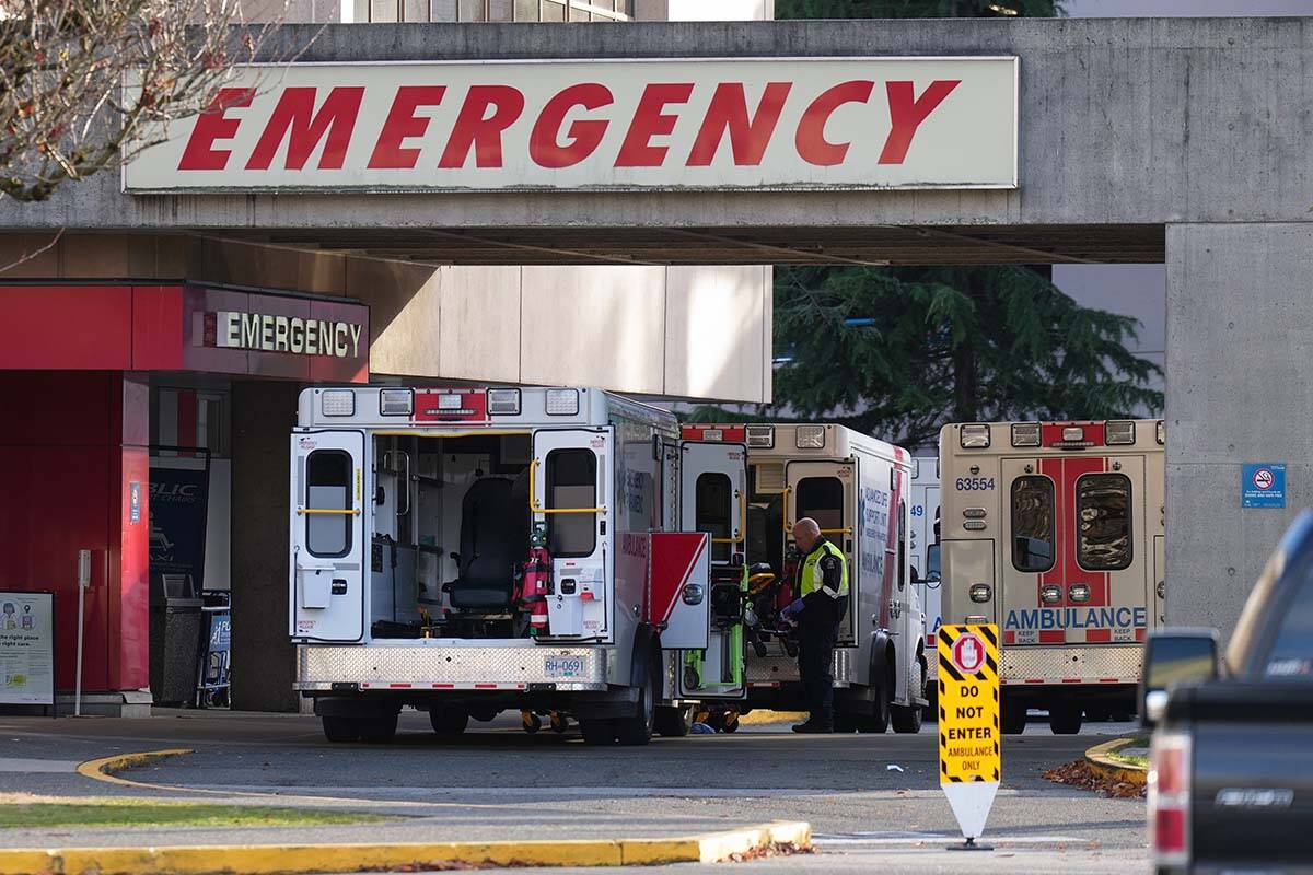 A paramedic is seen outside ambulances parked at the entrance to the emergency department at Richmond General Hospital, in Richmond, B.C., on November 27, 2022. The vast majority of B.C. paramedics and emergency dispatchers voted to approve a new three-year deal on Jan. 6, 2023. THE CANADIAN PRESS/Darryl Dyck