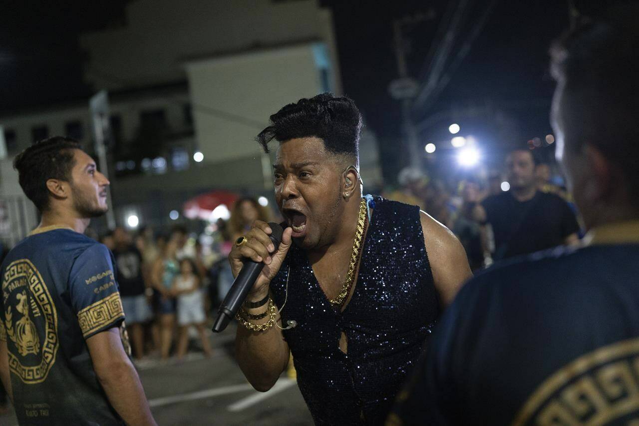 A member of Paraiso do Tuiuti samba school sings during a rehearsal in the streets ahead the Rio de Janeiro’s Carnival Parade, in Rio de Janeiro, Brazil, Monday, Feb.6, 2023. (AP Photo/Silvia Izquierdo)