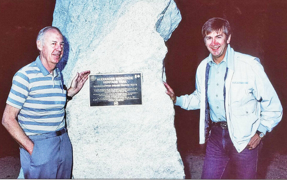 John Woodworth and Hälle Flygare at the bronze plaque placed on a granite boulder east of Burnt Bridge Creek in Tweedsmuir South Provincial Park on July 31, 1988 when the Alexander Mackenzie Heritage Trail was dedicated as a provincial heritage site. (Photo courtesy of Halle Flygare)
