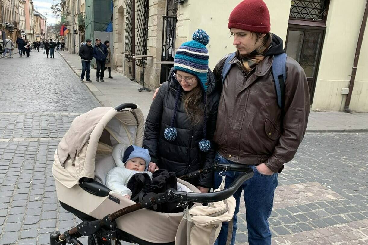 Olena Boiko and her husband Volodymyr take their 10-month-old son Yaroslav for a walk in the city centre of Lviv, Ukraine on Saturday, Feb. 18, 2023. Yaroslav was born in the bomb shelter of the hospital in Lviv a few months after the Russian invasion. THE CANADIAN PRESS/Laura Osman