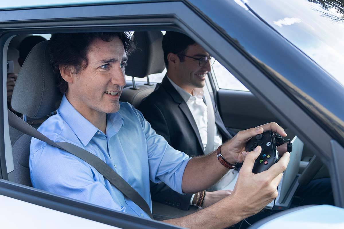 Prime Minister Justin Trudeau tries his hand at driving an intelligent electric vehicle during a visit to the University of Trois-Rivieres, Wednesday, January 18, 2023 in Shawinigan, Que. THE CANADIAN PRESS/Ryan Remiorz