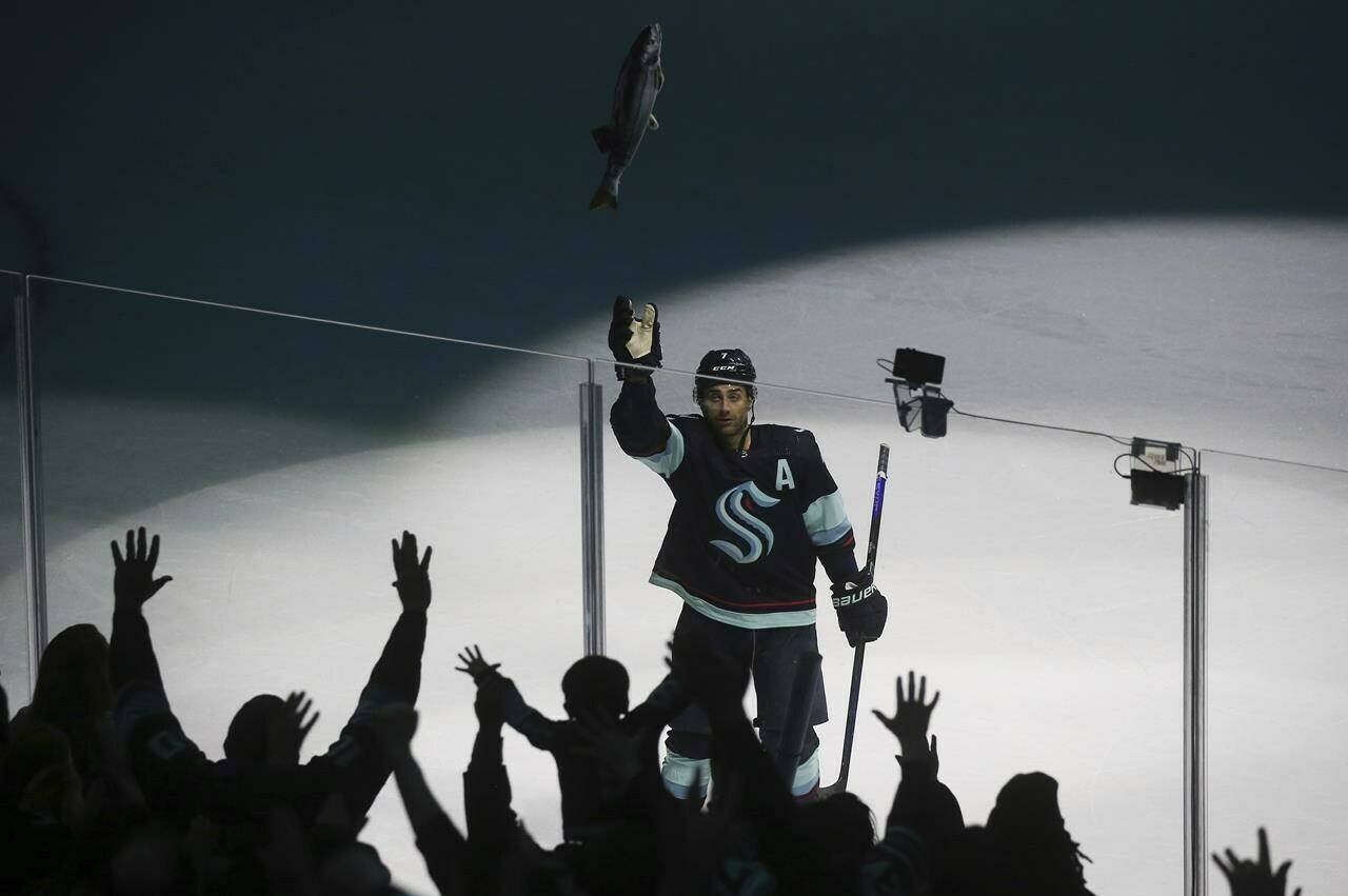 Seattle Kraken right wing Jordan Eberle (7) throws a stuffed salmon to fans as they celebrate the Kraken’s 4-2 win against the Detroit Red Wings in an NHL hockey game Saturday, Feb. 18, 2023, in Seattle. (AP Photo/Lindsey Wasson)