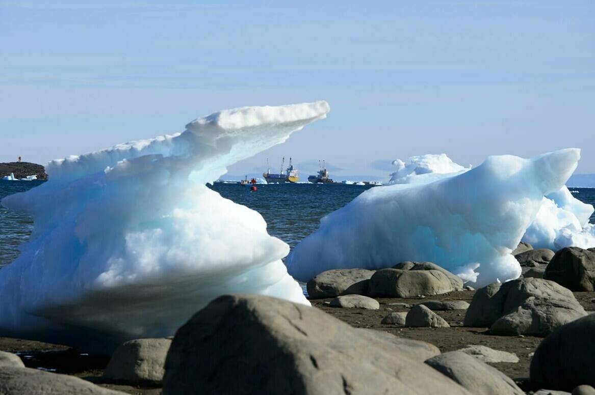 Ships are framed by pieces of melting sea ice in Frobisher Bay in Iqaluit, Nunavut on Wednesday, July 31, 2019. The Department of National Defence and Canadian Armed Forces confirm that they are aware of recent efforts by China to conduct surveillance operations in Canadian airspace and waters. THE CANADIAN PRESS/Sean Kilpatrick