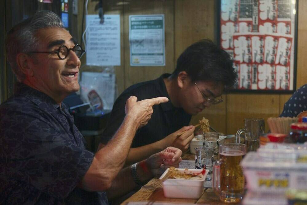 This image released by Apple TV+ shows actor Eugene Levy, left, in a scene from his new travel series “The Reluctant Traveler,” premiering Feb. 24. (Apple TV+ via AP)