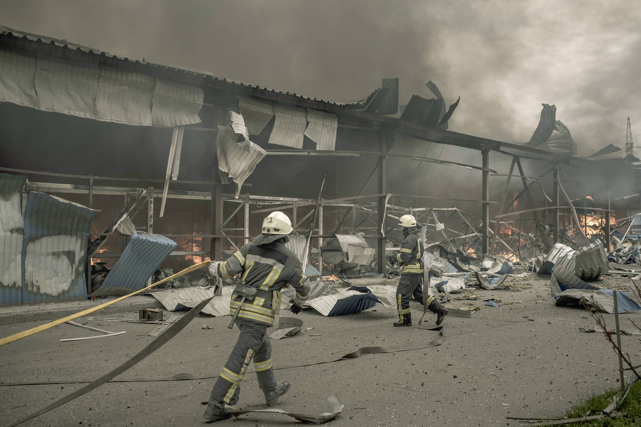 Firefighters work to extinguish a fire on a warehouse amid Russian bombardments in Kharkiv, Ukraine, Saturday, April 23, 2022. (AP Photo/Felipe Dana)