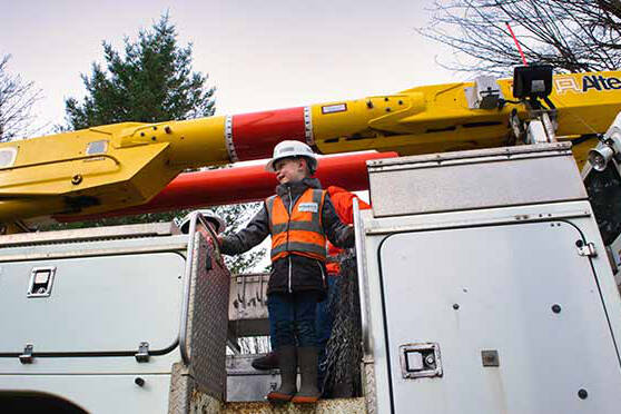 Finley Fulford, 6, stands on a BC Hydro bucket truck during a recent surprise visit. This bright young man from Agassiz is obsessed with all thing BC Hydro, beginning his illustrious career at age 3. (Photo/BC Hydro)