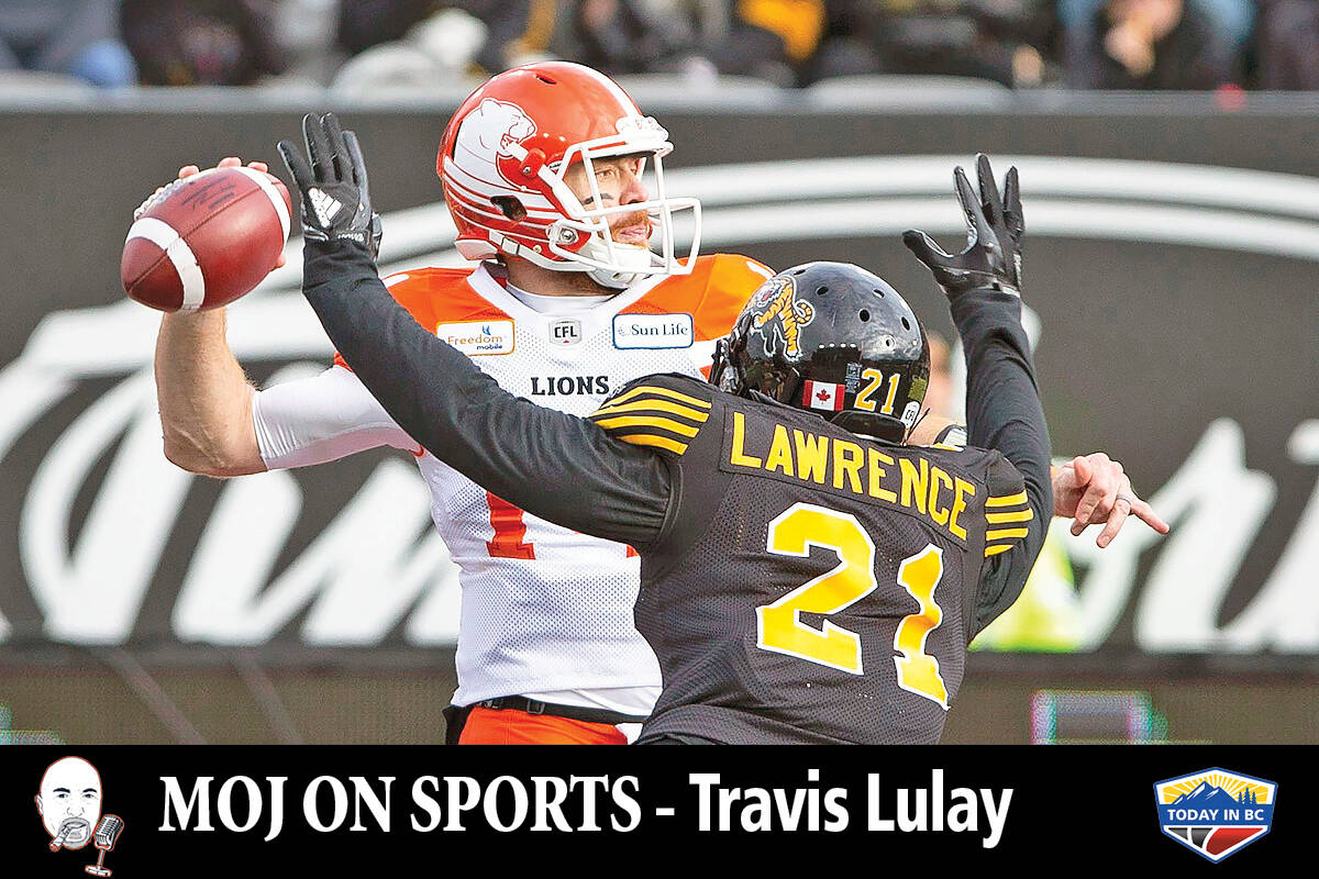 B.C. Lions quarterback Travis Lulay (14) is pressured by Hamilton Tiger-Cats linebacker Simoni Lawrence (21) during first half CFL Football division semifinal game action in Hamilton, Ont. on Sunday, November 11, 2018. (CANADIAN PRESS/Peter Power)