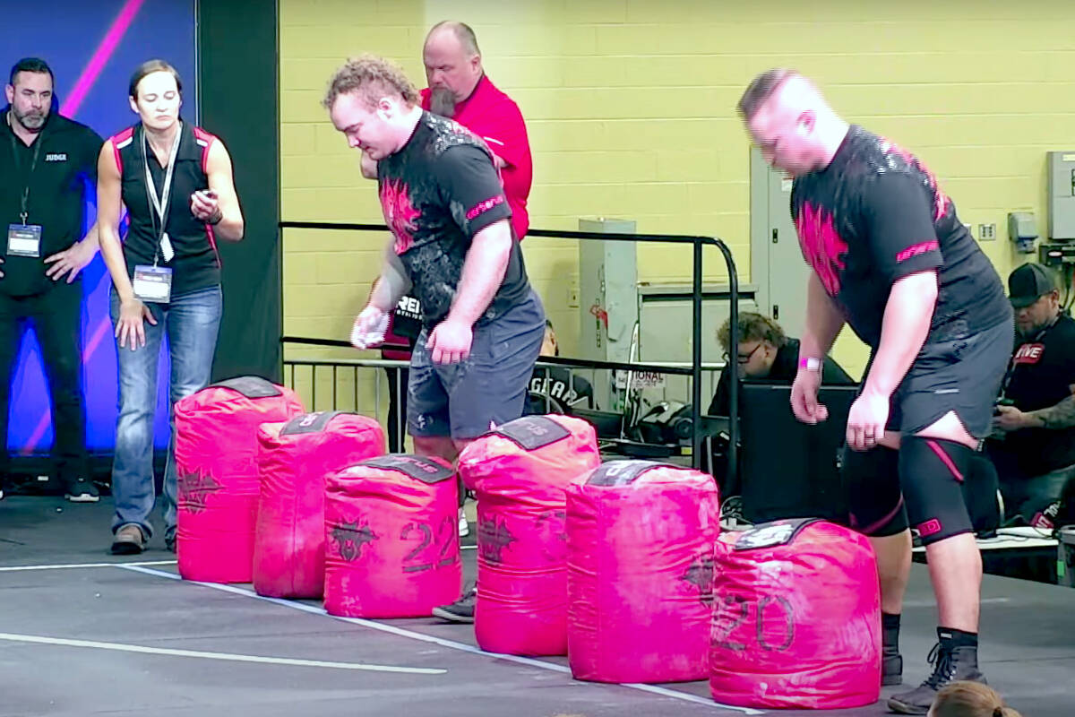 Cameron St. Amand (left) competed as a finalist in the 2023 World’s Strongest Firefighter Contest, which involved doing a sandbag carry. (Special to The News)