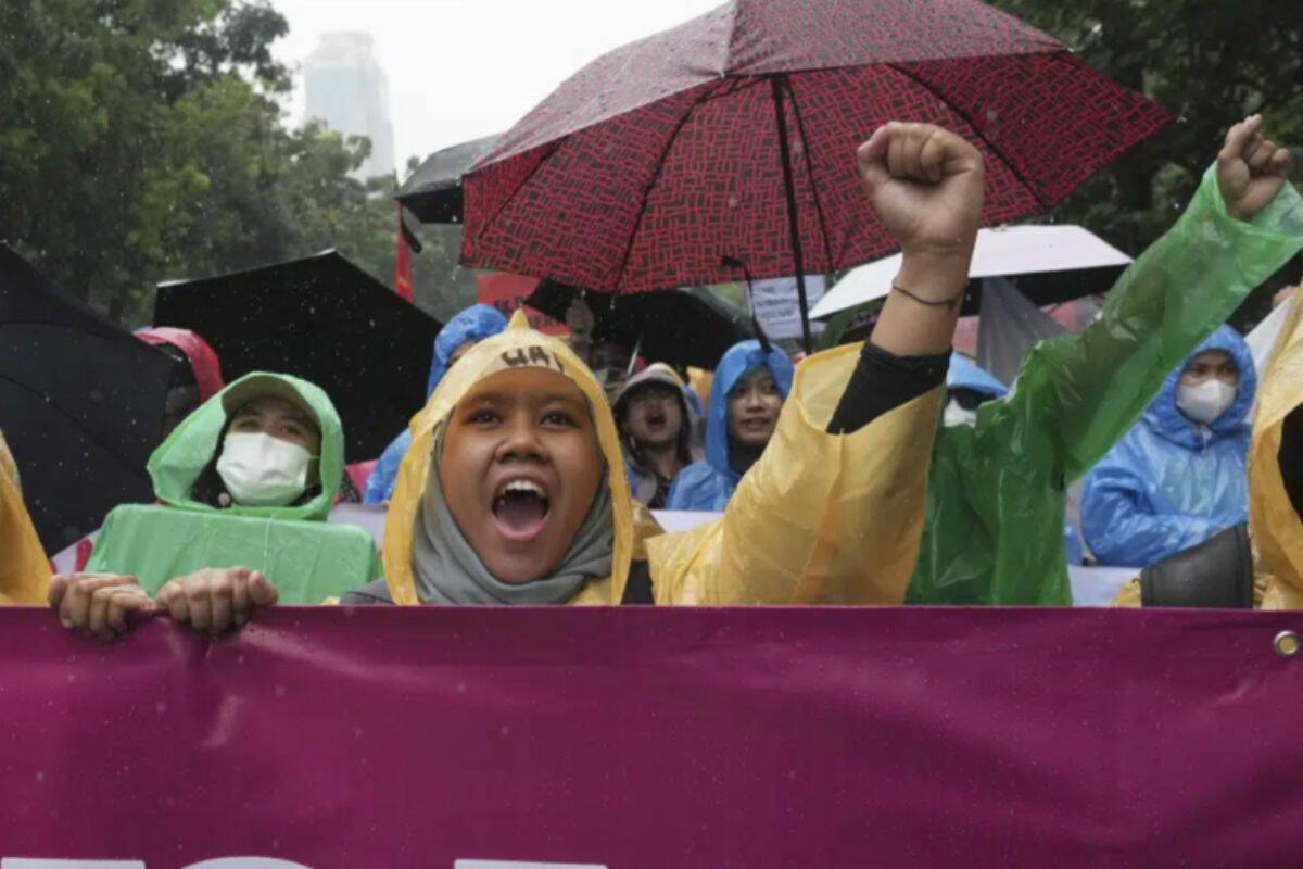 Women activists shout slogan during a rally celebrating International Women's Day in Jakarta, Indonesia, Wednesday, March 8, 2023. (AP Photo/Tatan Syuflana)