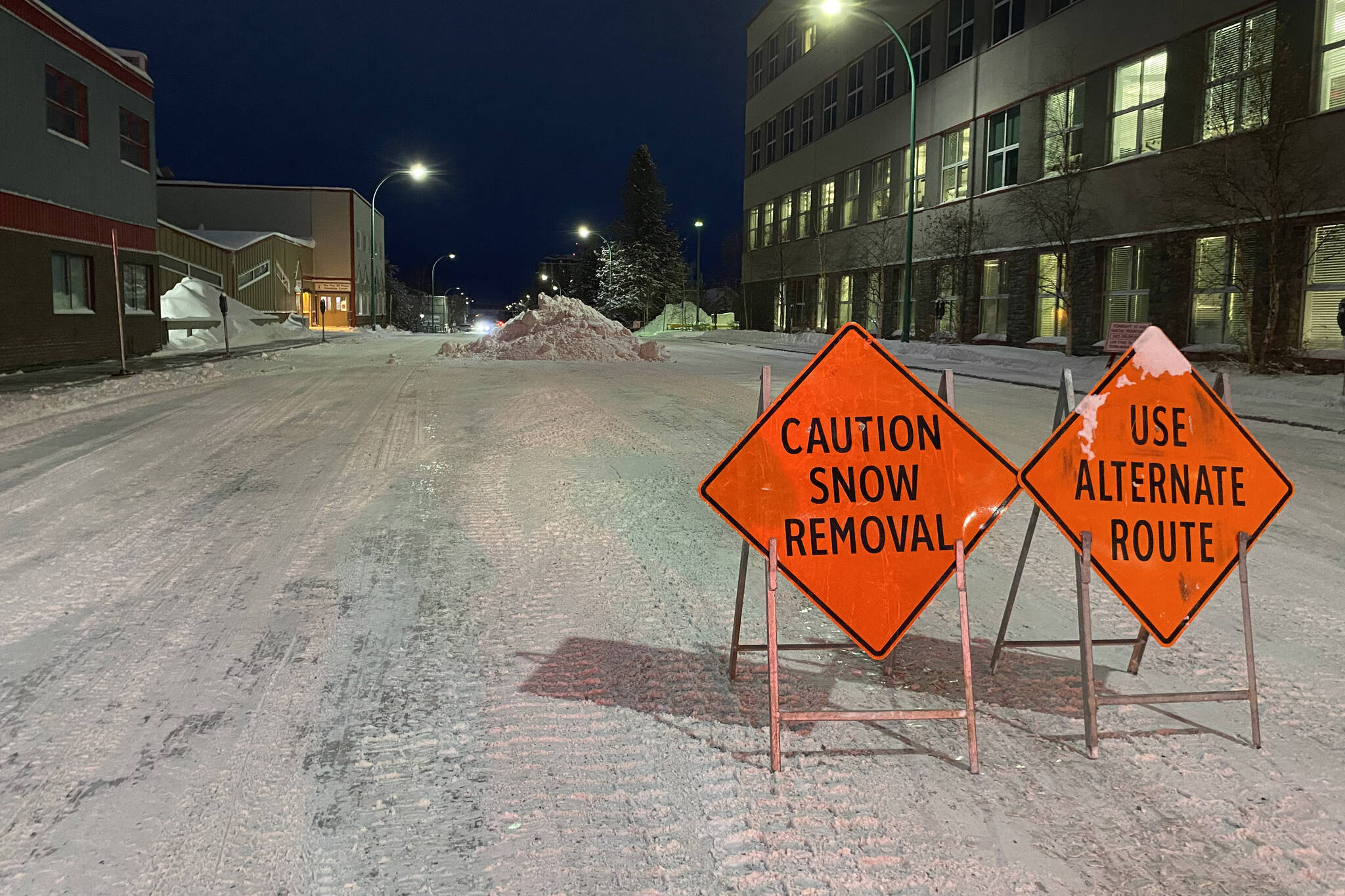 Snow removal signs and snow piled in the street are shown in Yellowknife, N.W.T., on Friday, Nov. 25, 2022. THE CANADIAN PRESS/Emily Blake