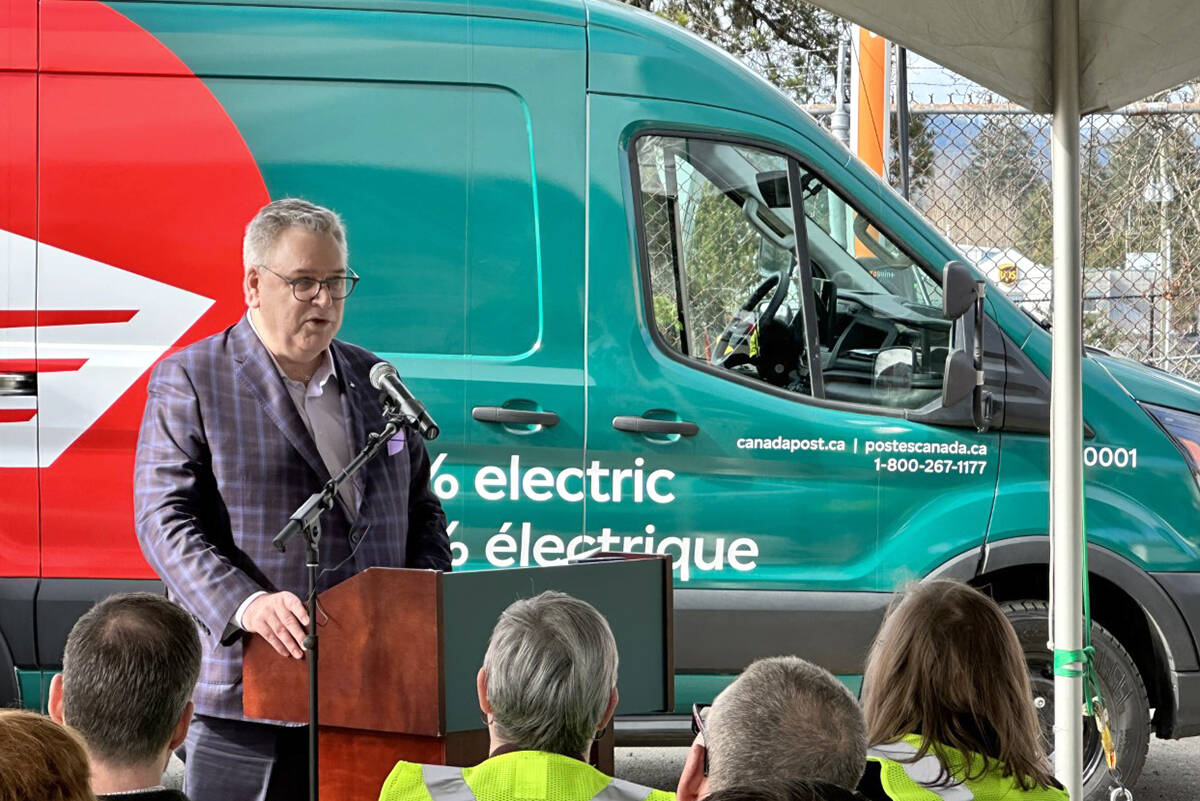 Doug Ettinger, president and CEO of Canada Post, speaks at a press conference announcing that Nanaimo’s Canada Post depot is the first in the country to boast an all-electric corporate delivery fleet. (Karl Yu/News Bulletin)