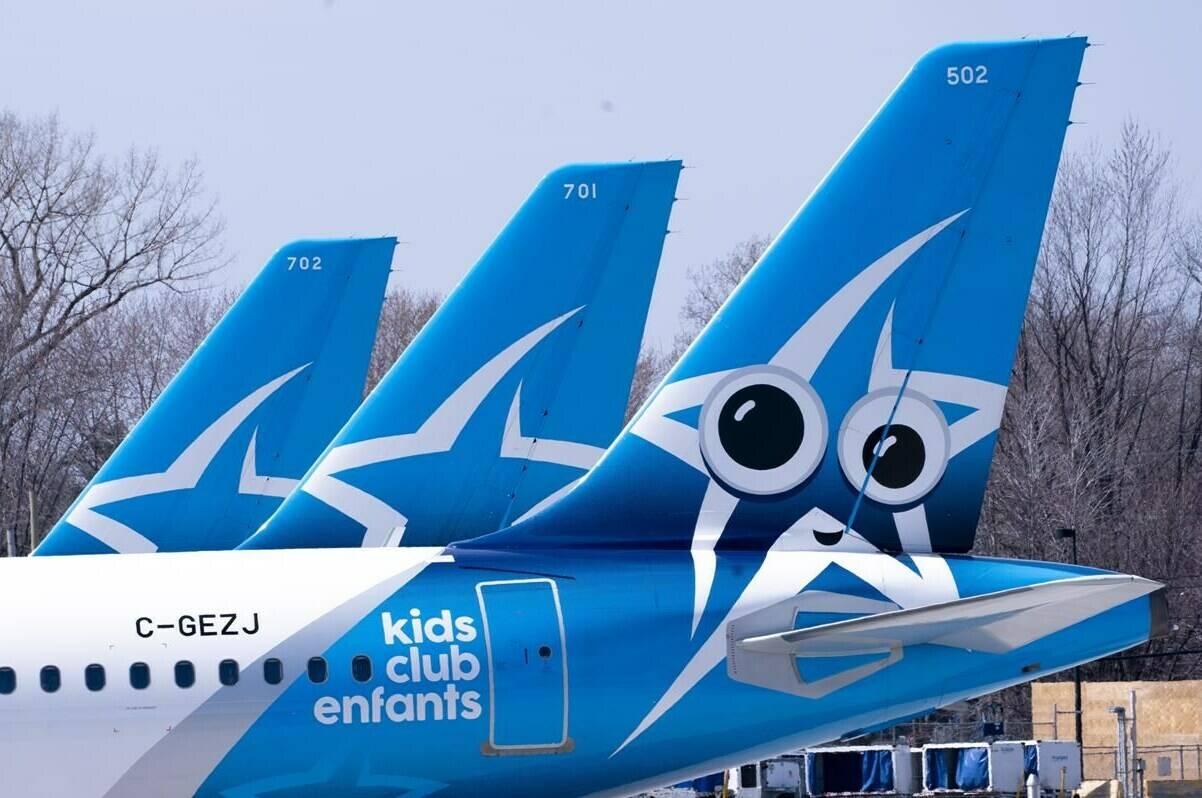 Air Transat aircraft are seen on the tarmac at Montreal-Trudeau International Airport in Montreal, on Wednesday, April 8, 2020. Transat AT Inc. reported a $56.6-million loss in its latest quarter compared with a loss of $114.3 million a year earlier as its revenue more than tripled. THE CANADIAN PRESS/Paul Chiasson