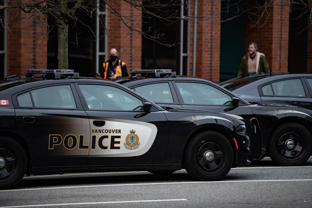 Police say a body has been found inside the remains of a burned tent at an encampment on Vancouver’s Downtown Eastside. Police cars are seen parked outside Vancouver Police Department headquarters in Vancouver, on Saturday, January 9, 2021. THE CANADIAN PRESS/Darryl Dyck