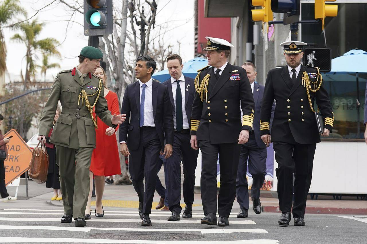 Britain’s Prime Minister Rishi Sunak, left to right, Col Jaimie Norman, Admiral Sir Ben Key, First Sea Lord, and Commander Gus Carnie during Sunak’s visit to San Diego, Monday March 13, 2023, ahead of his meetings with US President Joe Biden and Prime Minister of Australia Anthony Albanese as part of AUKUS. Experts are warning that Canada’s omission from the military pact involving three of its closest allies is symptomatic of a larger problem in how this country is perceived by its friends. THE CANADIAN PRESS/Stefan Rousseau-Pool via AP