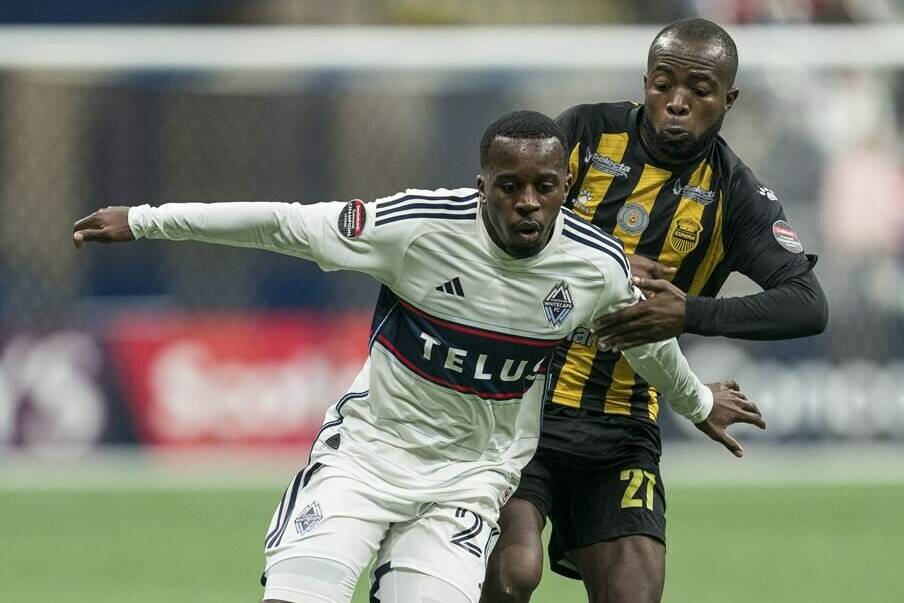 Real Espana’s Gerson Chavez (right) grabs a hold of Vancouver Whitecaps FC’s JC Ngando during second half CONCACAF Champions League soccer action in Vancouver, B.C., Wednesday, March 8, 2023. Despite tough travel and punishing weather, the Vancouver Whitecaps know they have the upper hand as they prepare for CONCACAF Champions League play this week.THE CANADIAN PRESS/Rich Lam