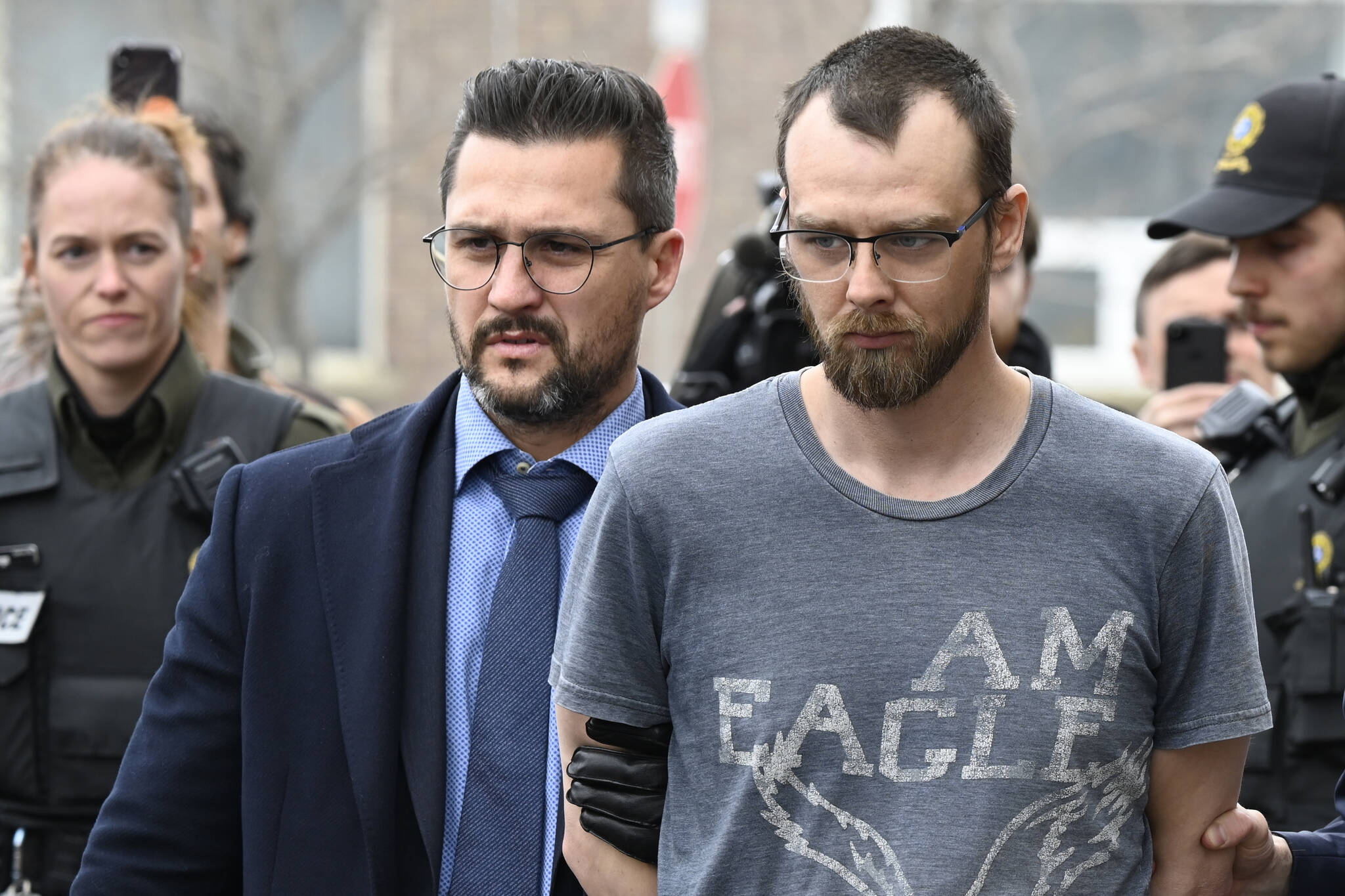 Steeve Gagnon is escorted by police out of court in Amqui, Que., Tuesday, March 14, 2023. Gagnon is facing charges relating to an incident where a driver of a pickup truck drove into pedestrians, killing two people and injuring nine. THE CANADIAN PRESS/Jacques Boissinot