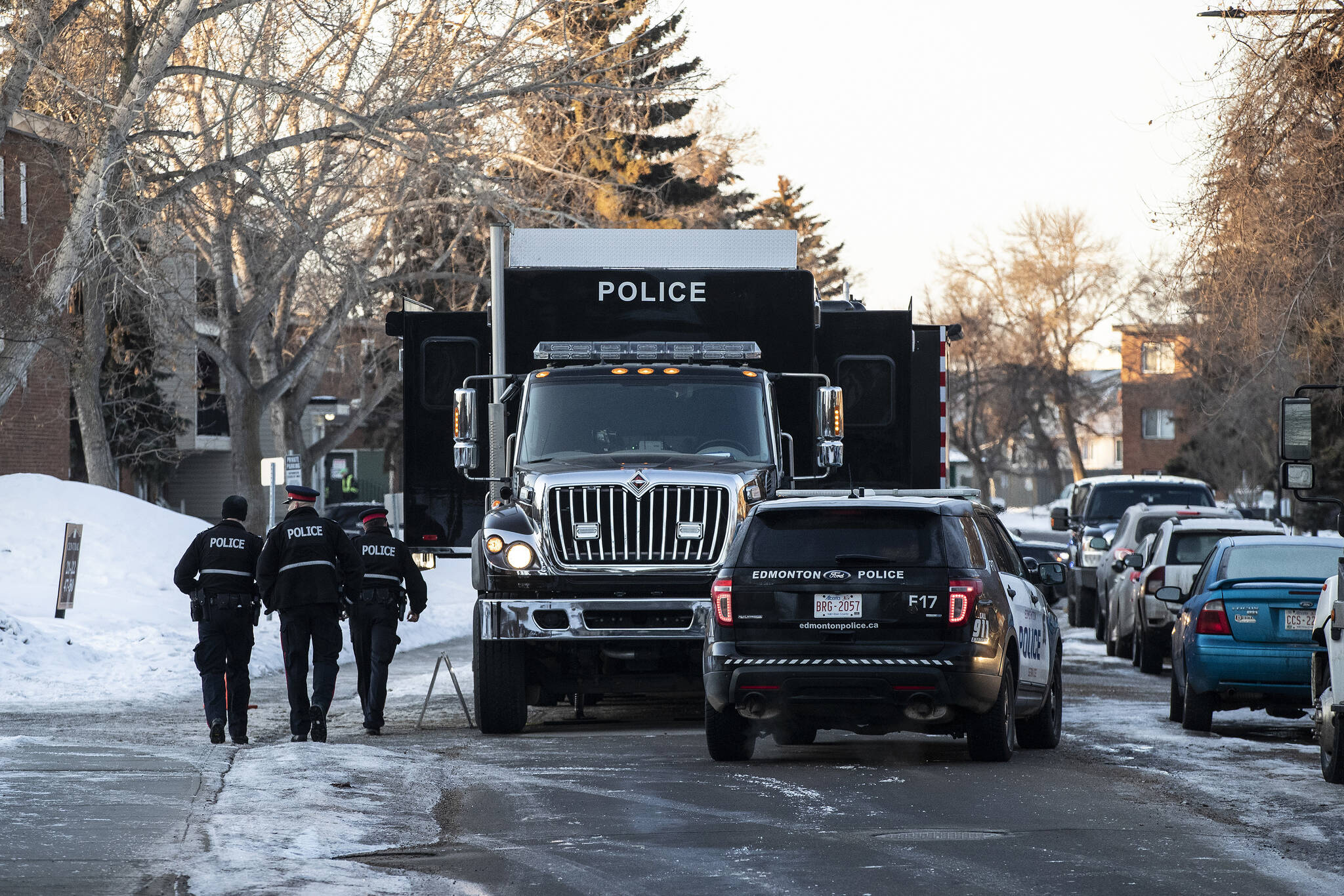 Police investigate the scene where two officers were shot and killed on duty in Edmonton on Thursday, March 16, 2023. THE CANADIAN PRESS/Jason Franson