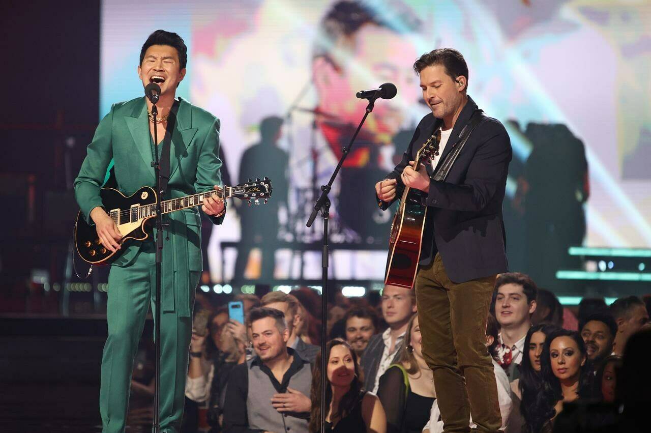 Simu Liu, left, and Ryan Peake of Nickelback perform during the Juno Awards in Edmonton on Monday, March 13, 2023. THE CANADIAN PRESS/Timothy Matwey