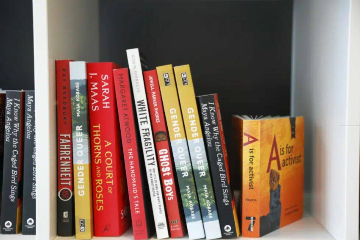 Books are displayed at the Banned Book Library at American Stage in St. Petersburg, Fla., Feb. 18, 2023. In Florida, some schools have covered or removed books under a new law that requires an evaluation of reading materials and for districts to publish a searchable list of books where individuals can then challenge specific titles. (Jefferee Woo/Tampa Bay Times via AP)