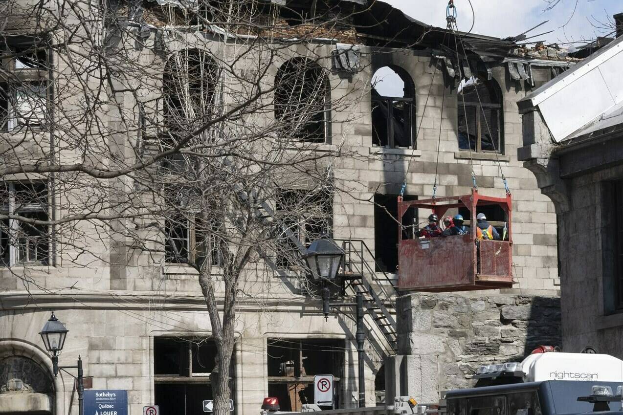 Firefighters continue the search for victims Monday, March 20, 2023 at the scene of last week’s fire that left one person dead and six people missing in Montreal.THE CANADIAN PRESS/Ryan Remiorz