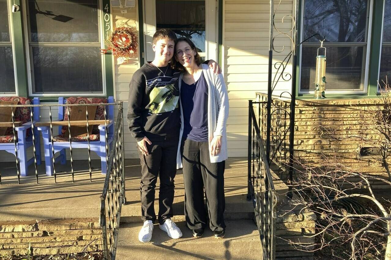 Al Stone-Gebhardt and his mother, Erika Dubose, pose for a photo outside their home on Friday, March 3, 2023, in Tulsa, Okla. As hundreds of bills nationwide take aim at nearly every facet of transgender existence, from health care to athletics to bathroom access, trans kids like Stone-Gebhardt and their families say certain proposals could eliminate one of the last remaining safe havens to explore their identities: K-12 public schools. (AP Photo/Sean Murphy)