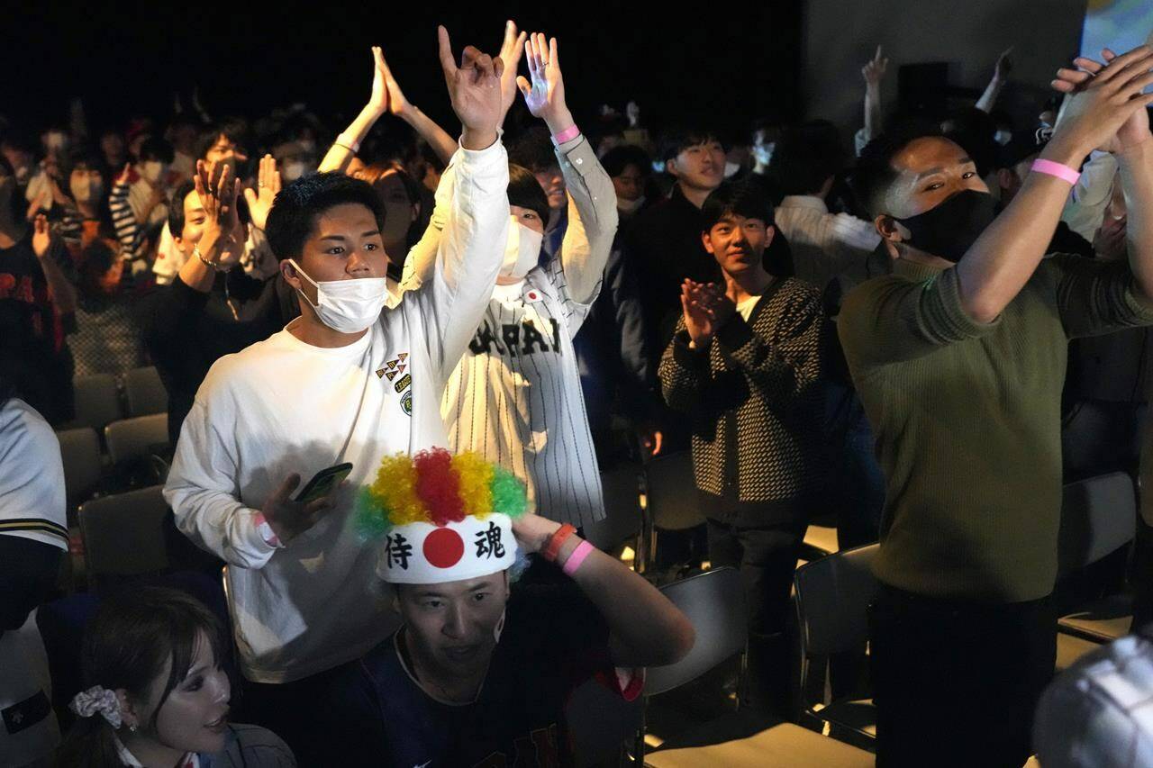 People celebrate Japan’s victory against United States as they watch on a live stream of a World Baseball Classic (WBC) final being played at LoanDepot Park in Miami, during a public viewing event Wednesday, March 22, 2023, in Tokyo. (AP Photo/Eugene Hoshiko)