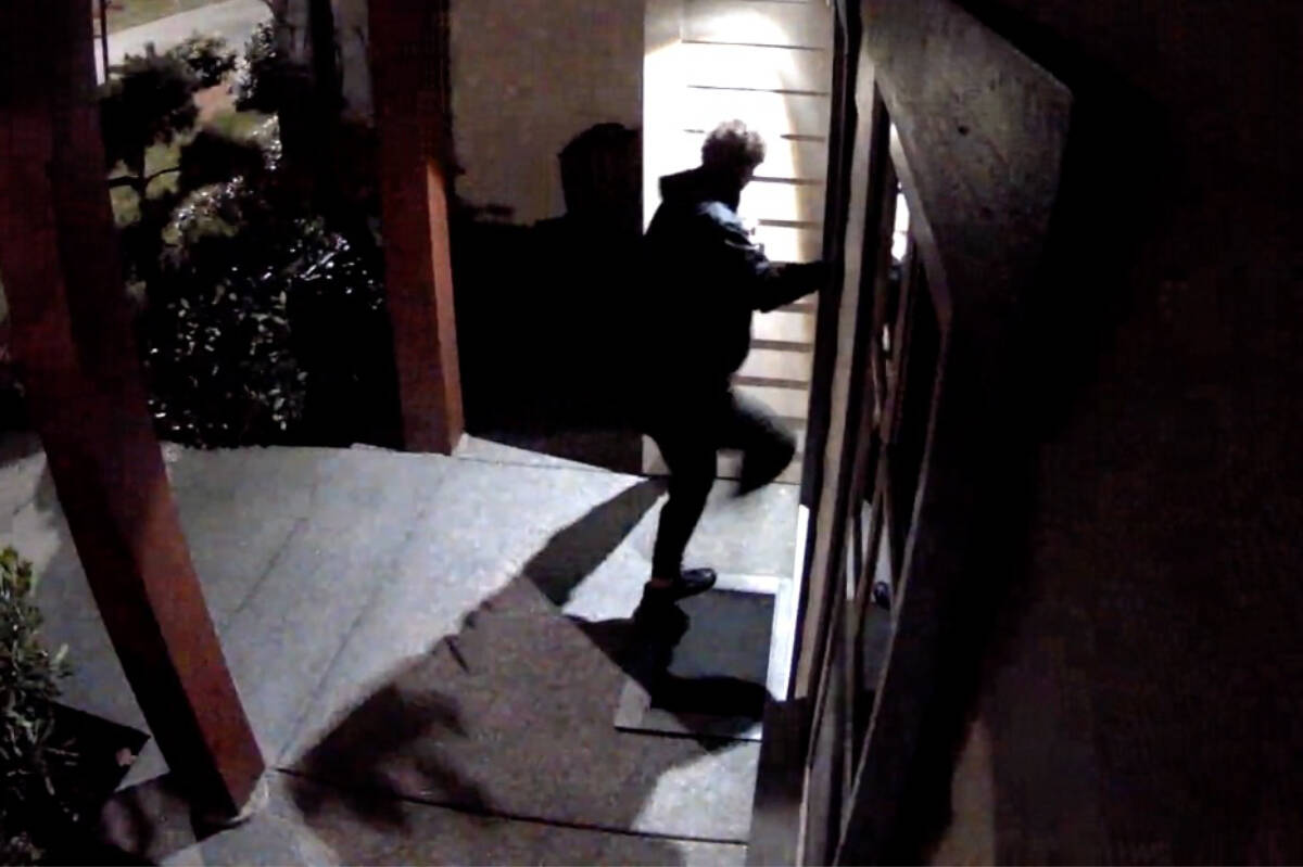 Home security video captures a person kicking at a front door, part of a TikTok challenge. Photo via video reel