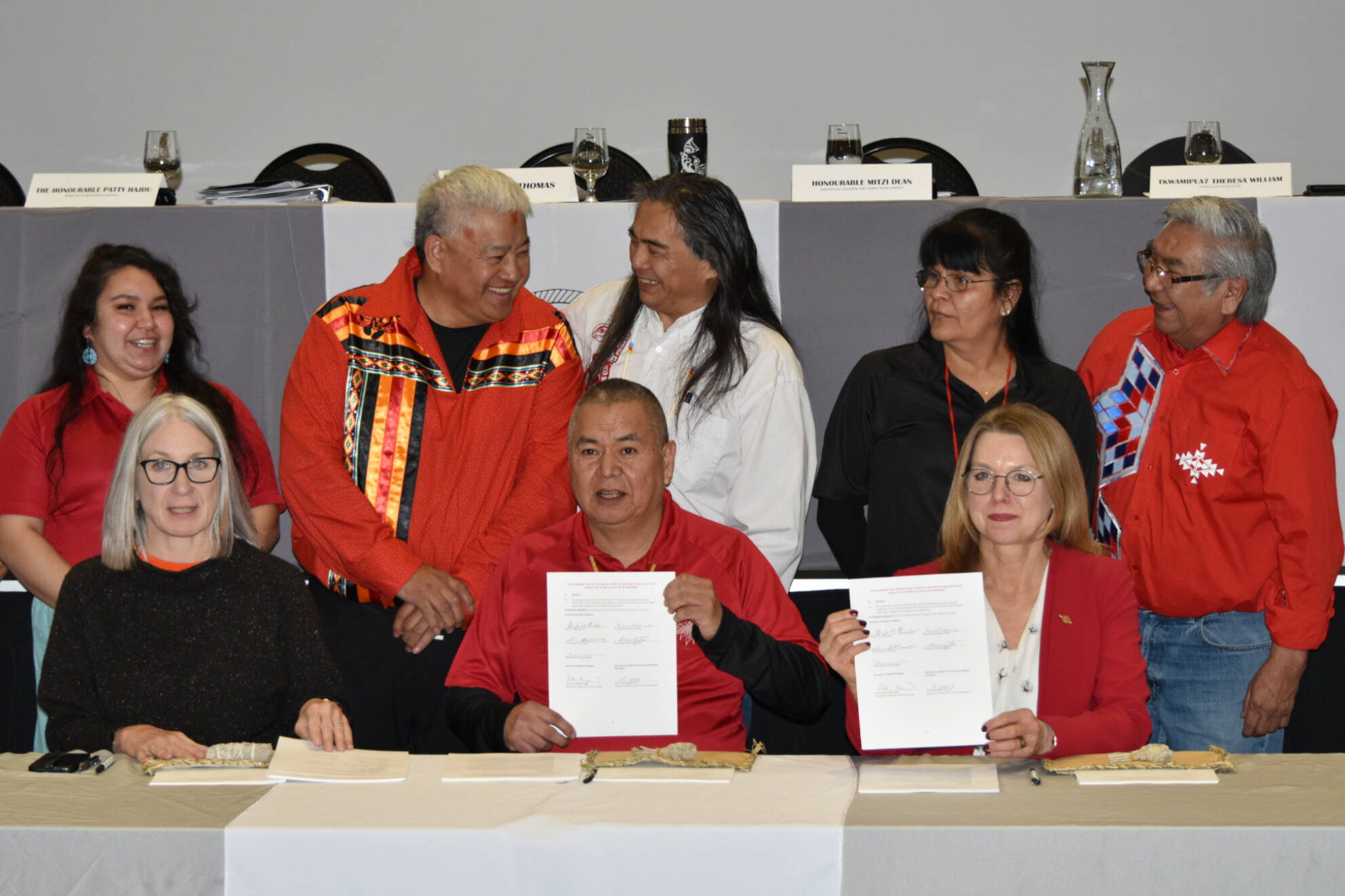 (Left to right) Splatsin Tkwamipla7 Sabrina Vergata, Wenecwtsin Wayne Christian, Elder George William, and Tkwamipla7 (councillors) Theresa William and Leonard Edwards look on as (front, left to right) Federal Minister of Indigenous Services Patty Hajdu, Splatsin Kukpi7 Doug Thomas and B.C. Minister of Children and Family Development Mitzi Dean hold up the signed coordination agreement. Federal and provincial officials, Kukpi7 Thomas and all Tkwamipla7 members signed the agreement. (Rebecca Willson/ Eagle Valley News)